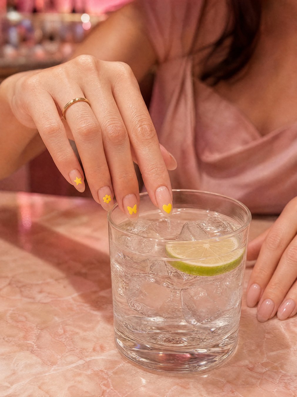 Dipping the nail with the yellow sticker into a gin and tonic